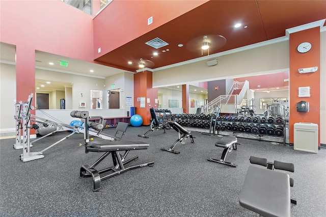 workout area featuring ornamental molding, visible vents, and recessed lighting