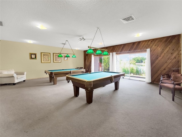 rec room featuring a textured ceiling, wooden walls, carpet floors, billiards, and visible vents