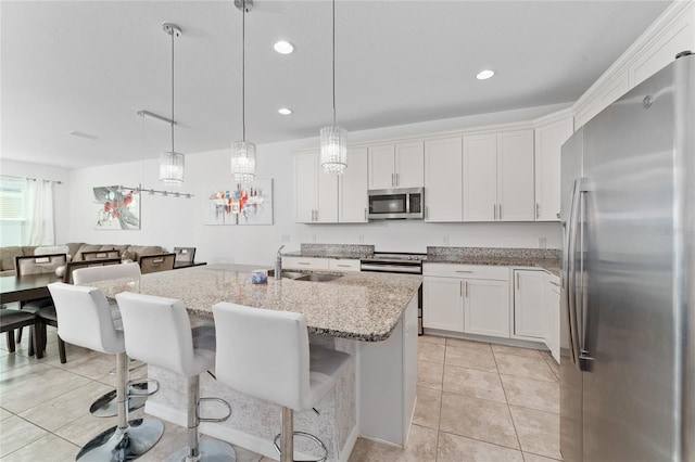 kitchen featuring light tile patterned floors, appliances with stainless steel finishes, sink, and white cabinetry