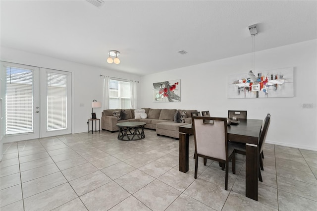 dining space featuring french doors and light tile patterned floors