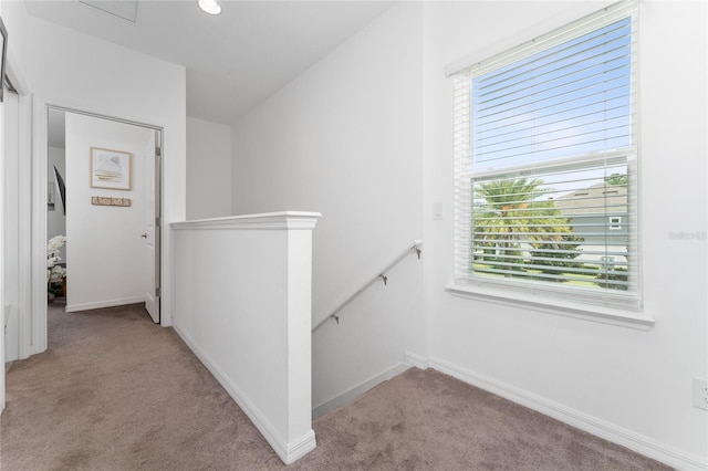 corridor featuring light colored carpet