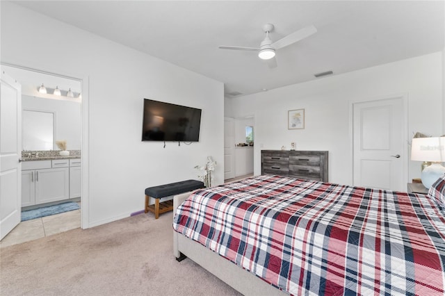 carpeted bedroom featuring ceiling fan and ensuite bathroom