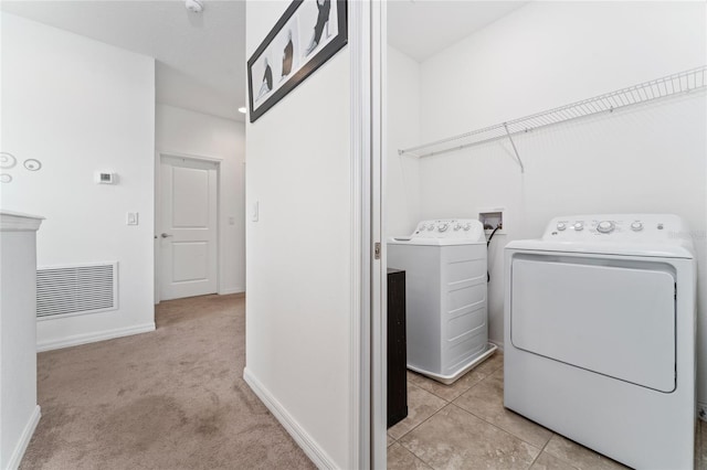 washroom featuring light carpet and independent washer and dryer