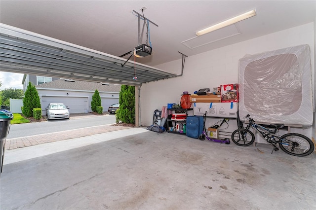 garage with a carport and a garage door opener