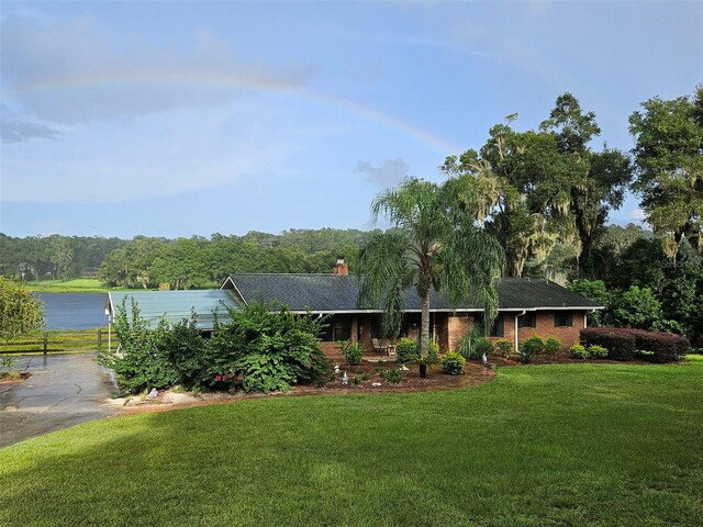 single story home featuring a water view and a front yard