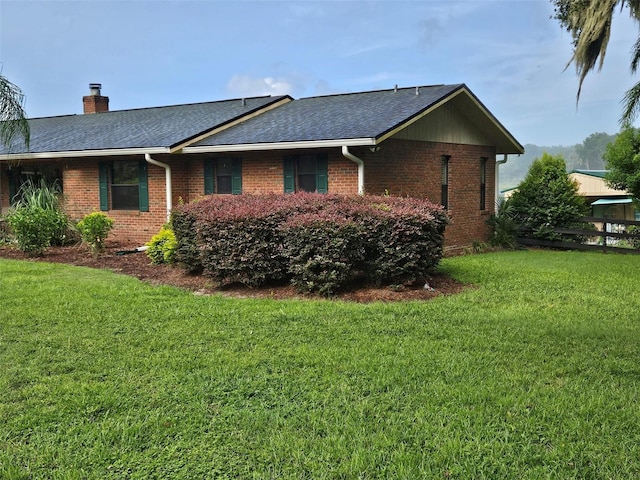 view of side of home featuring a lawn