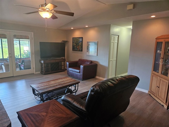 living room featuring light wood-type flooring, french doors, vaulted ceiling, and ceiling fan