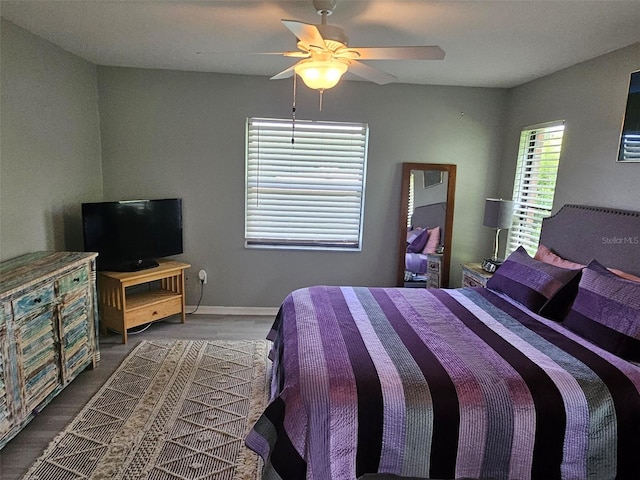 bedroom with ceiling fan and dark wood-type flooring