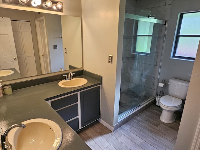 bathroom with vanity, hardwood / wood-style floors, toilet, and walk in shower