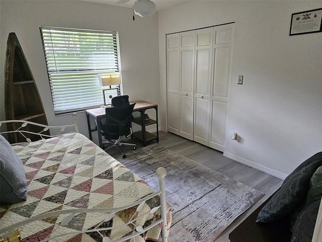 bedroom featuring a closet and dark hardwood / wood-style floors