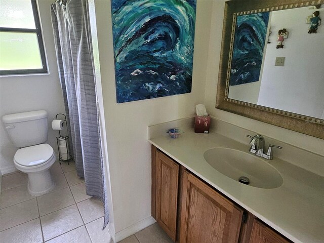 bathroom featuring toilet, vanity, and tile patterned floors