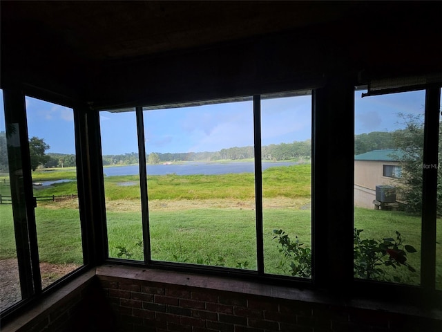 unfurnished sunroom with a water view