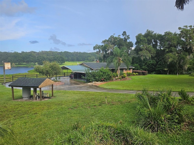 view of yard featuring a water view and a carport