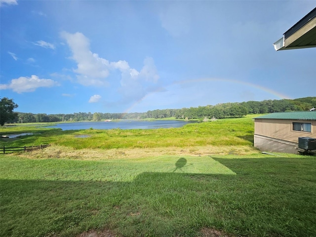 view of yard featuring central AC unit and a water view