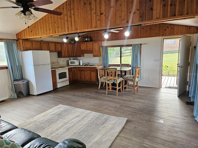 kitchen featuring ceiling fan, sink, white appliances, and light wood-type flooring