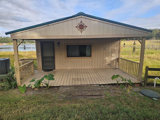 exterior space featuring cooling unit, a water view, and covered porch