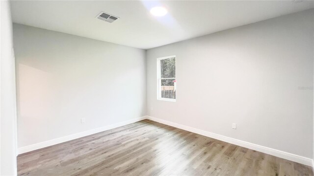 spare room with wood-type flooring