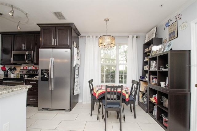 kitchen featuring dark brown cabinetry, visible vents, appliances with stainless steel finishes, light stone countertops, and a notable chandelier