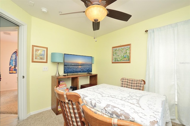 dining space with visible vents, carpet floors, a ceiling fan, and baseboards