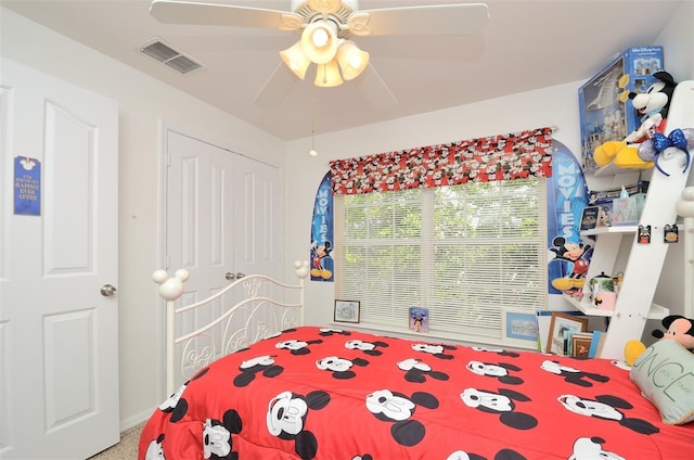 bedroom with ceiling fan, visible vents, and a closet