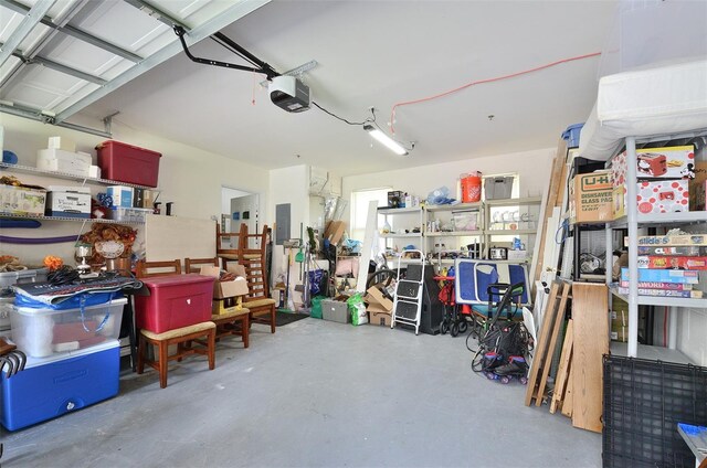 garage with a garage door opener and electric panel