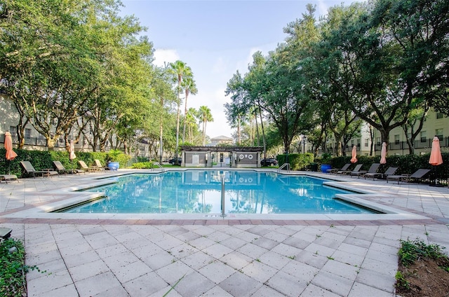 pool featuring a patio area and fence