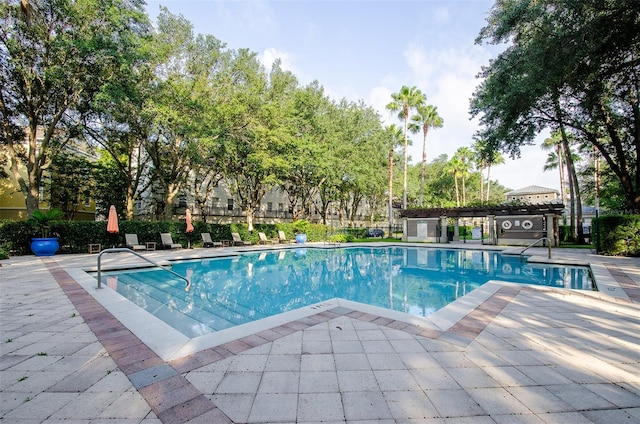 community pool featuring a patio and fence