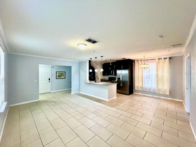 kitchen featuring stainless steel fridge, visible vents, a sink, and ornamental molding