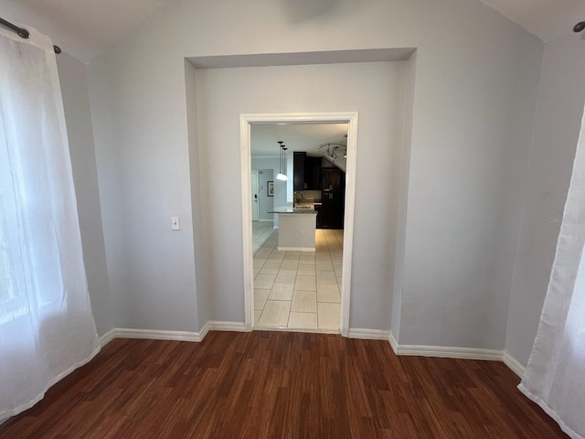 hall featuring light wood finished floors and baseboards