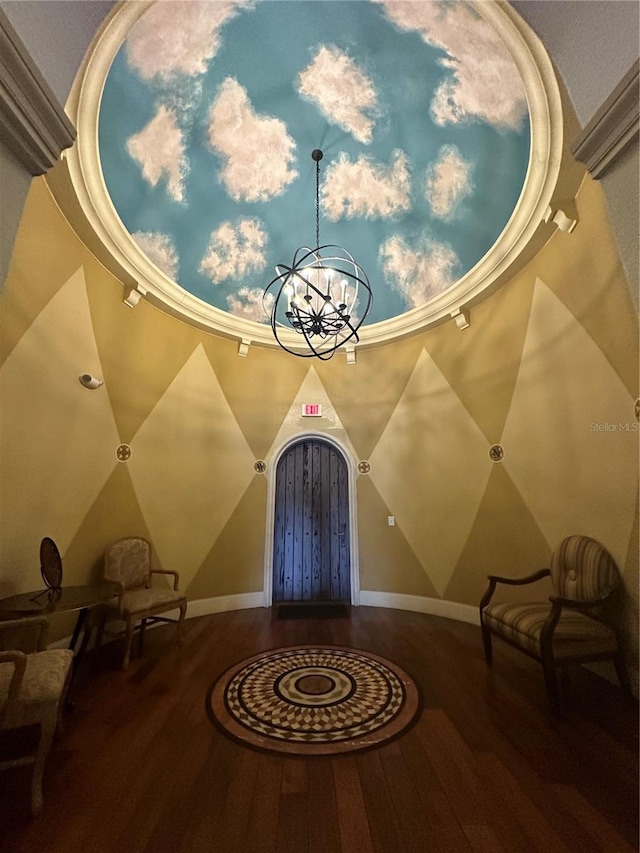 foyer entrance with an inviting chandelier and wood-type flooring