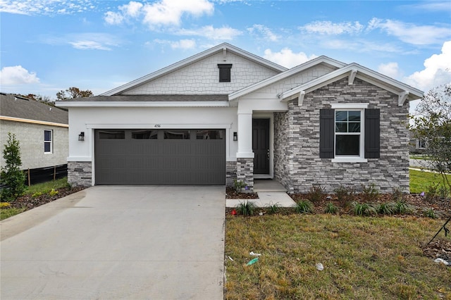 craftsman inspired home with a garage and a front lawn