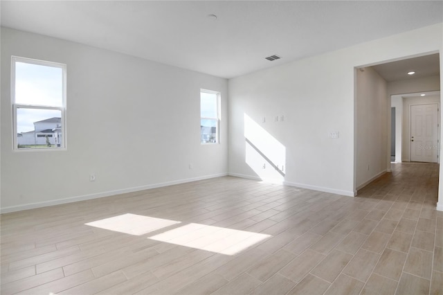 spare room with light wood-type flooring