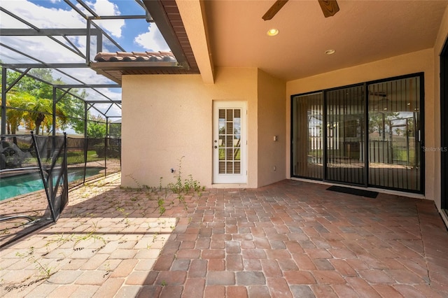 view of patio featuring ceiling fan, a lanai, and a fenced in pool