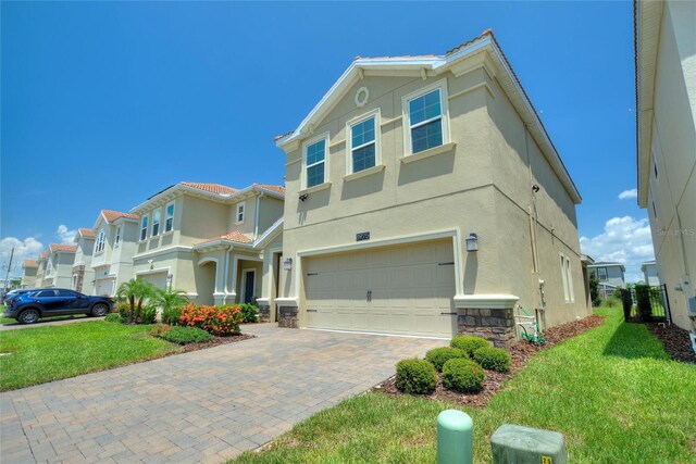 view of front of property featuring a garage and a front lawn