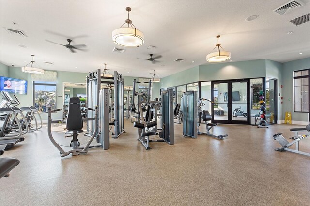 exercise room with ceiling fan, french doors, and a textured ceiling