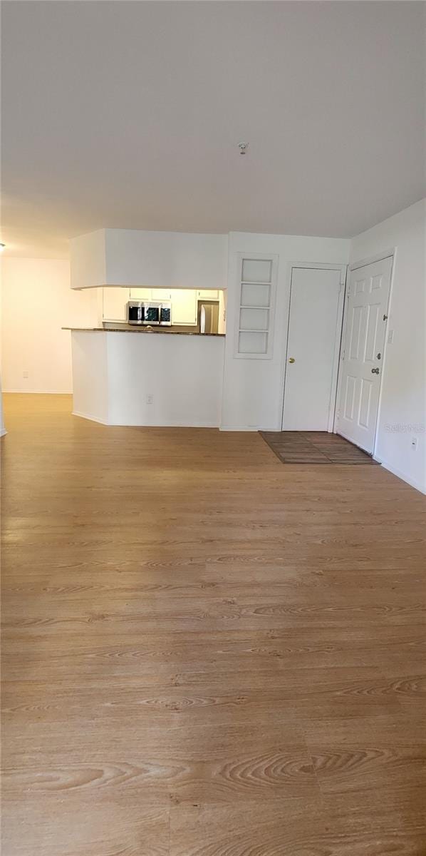 unfurnished living room with light wood-type flooring