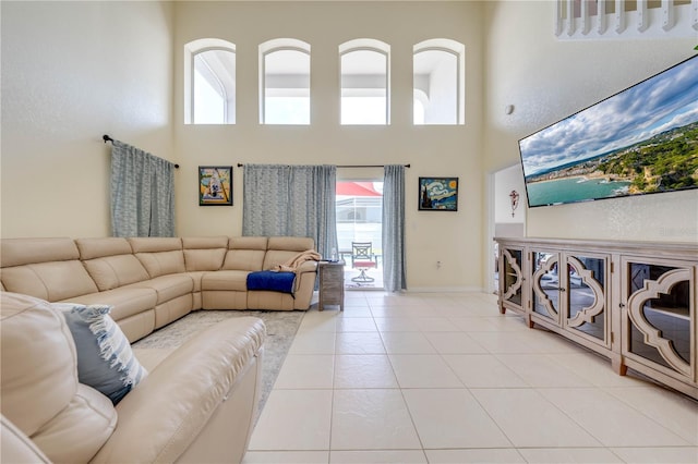 tiled living room featuring a high ceiling