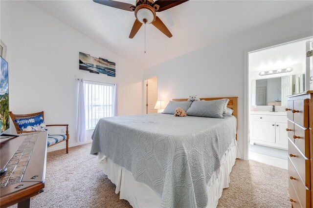 bedroom featuring ensuite bathroom, vaulted ceiling, light colored carpet, and ceiling fan