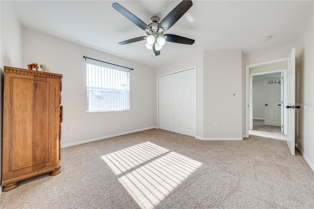 carpeted bedroom featuring ceiling fan and a closet