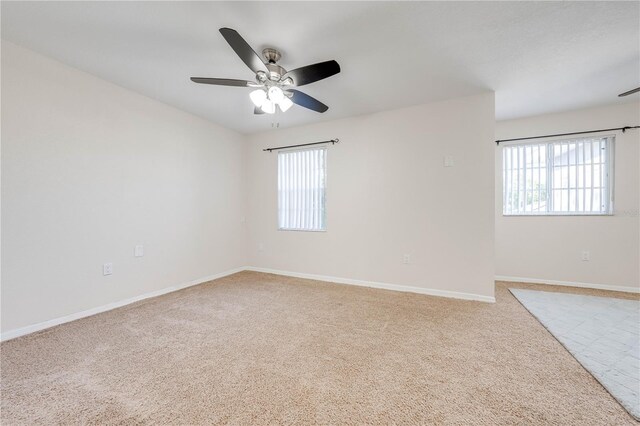 spare room featuring ceiling fan and light colored carpet