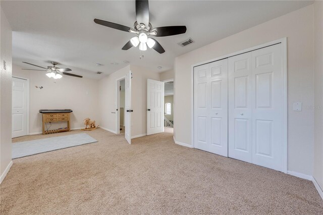 unfurnished living room featuring ceiling fan and light colored carpet