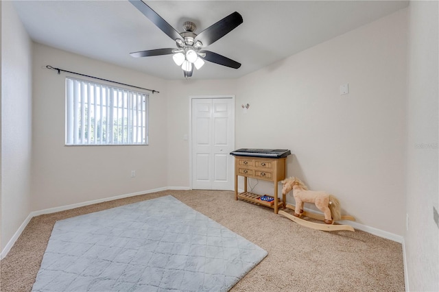 bedroom featuring light carpet, a closet, and ceiling fan