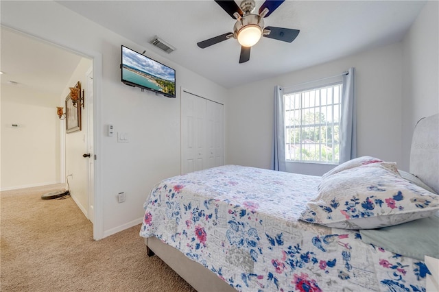 bedroom with ceiling fan, a closet, and carpet