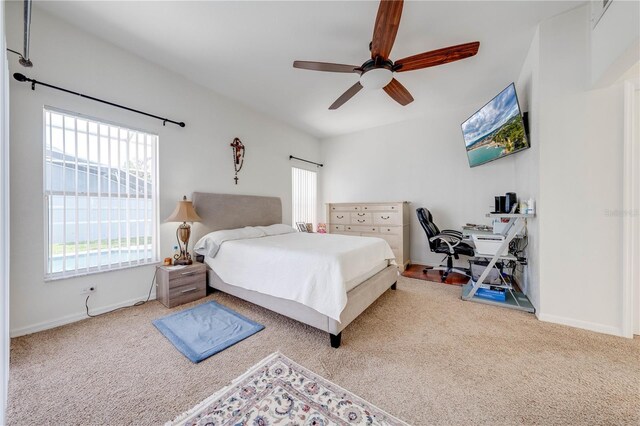 bedroom with ceiling fan and light colored carpet