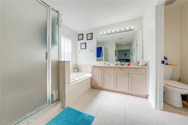 full bathroom featuring double sink vanity, toilet, plus walk in shower, and tile patterned flooring