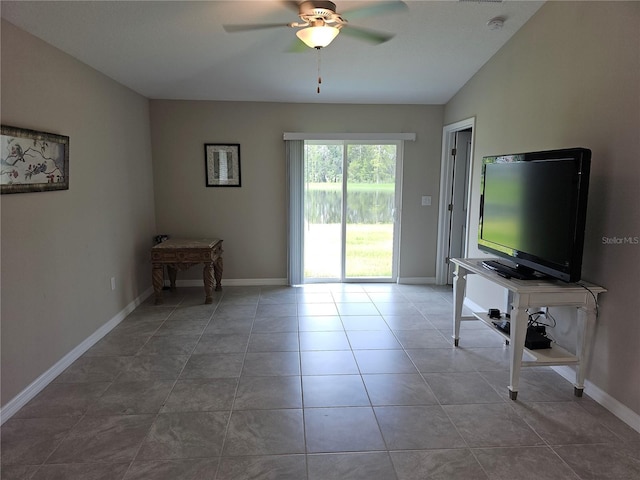 unfurnished living room with tile patterned flooring, lofted ceiling, a ceiling fan, and baseboards