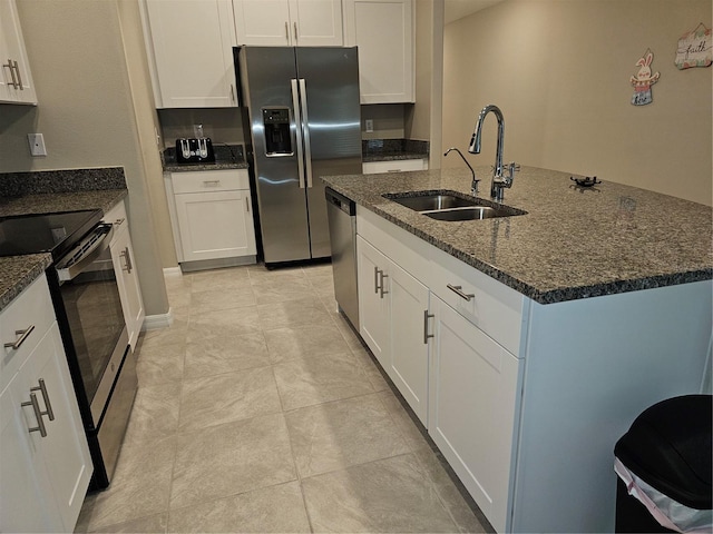 kitchen with a sink, appliances with stainless steel finishes, and white cabinets