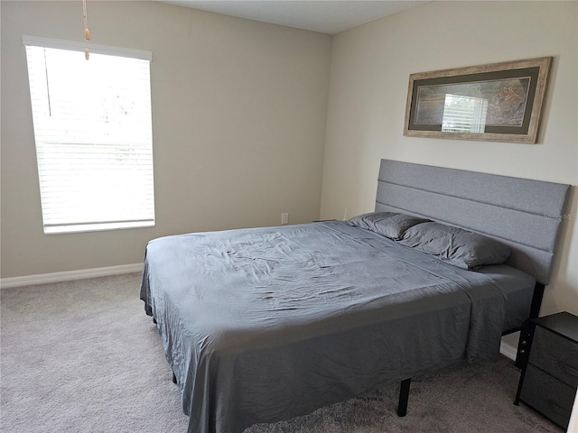 carpeted bedroom with baseboards