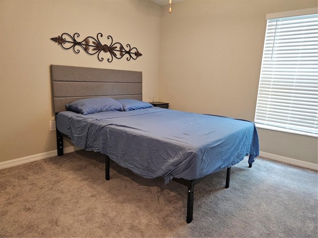 bedroom featuring baseboards and carpet floors