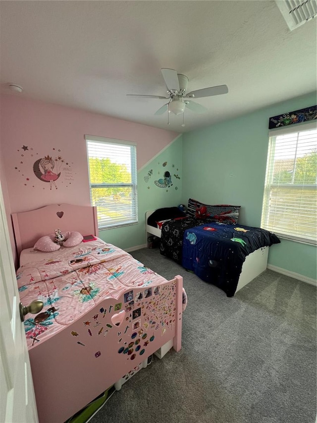 bedroom featuring ceiling fan, carpet flooring, visible vents, and baseboards